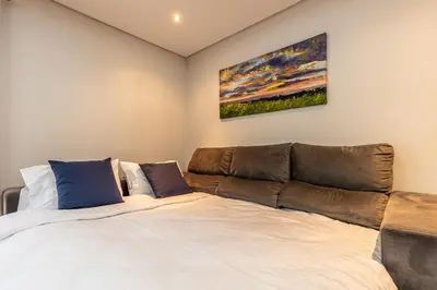 a bedroom with a bed and a couch at Machico City Apt in Machico