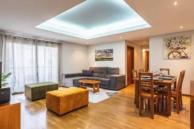 a living room with a couch and a table at Machico City Apt in Machico