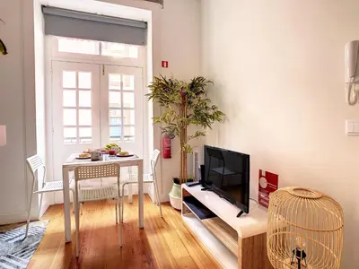 a living room with a table and a television at FX City Life by LovelyStay in Funchal