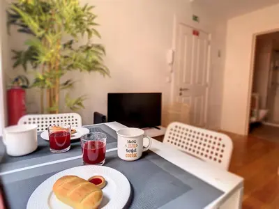 a table with a plate of food and drinks on it at FX City Life by LovelyStay in Funchal