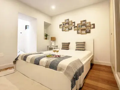 a bedroom with a large white bed in a room at FX City Life by LovelyStay in Funchal