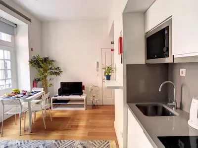 a kitchen and dining room with a table and a television at FX City Life by LovelyStay in Funchal