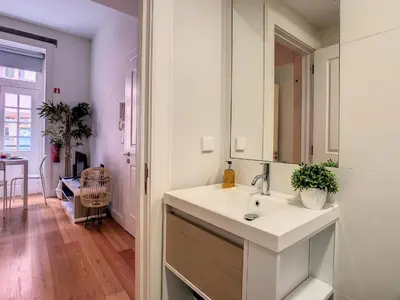 a white bathroom with a sink and a mirror at FX City Life by LovelyStay in Funchal