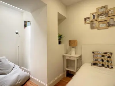 a bedroom with a bed and a table with a lamp at FX City Life by LovelyStay in Funchal