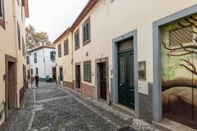 an alley in an old town with a painting on the wall at Amazing Old Town - Apartments by SBH in Funchal
