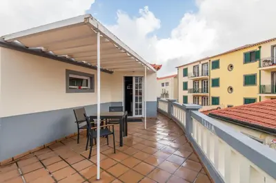 a balcony with a pergola and a table and chairs at Amazing Old Town - Apartments by SBH in Funchal