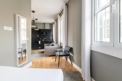 a living room with a chair and a table in a room at Amazing Old Town - Apartments by SBH in Funchal