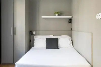 a bedroom with a white bed with a black pillow at Amazing Old Town - Apartments by SBH in Funchal
