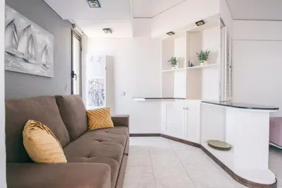 a living room with a couch and a kitchen at Sunny Bayhill with swimming pool in Funchal