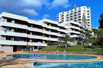 a building with a swimming pool in front of a building at Sunny Bayhill with swimming pool in Funchal