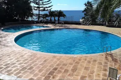 a large swimming pool with blue water at Sunny Bayhill with swimming pool in Funchal