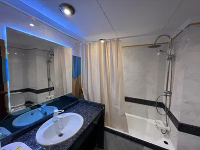 a bathroom with a sink and a shower and a tub at Sunny Bayhill with swimming pool in Funchal