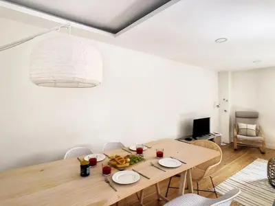 a dining room with a wooden table and chairs at FX City Lover by LovelyStay in Funchal