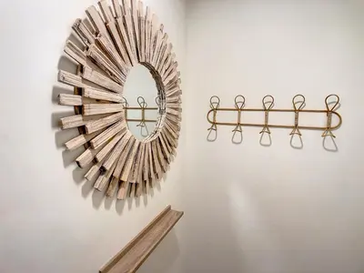 a mirror hanging on a wall next to a shelf at FX City Lover by LovelyStay in Funchal