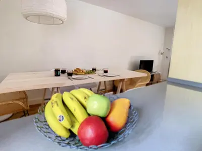 a bowl of fruit on a counter with a table at FX City Lover by LovelyStay in Funchal
