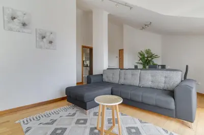 a living room with a couch and a stool at Desert Island Apartment by Atlantic Holiday in Caniço