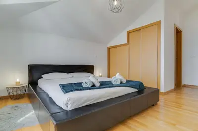 a bedroom with a large bed with towels on it at Desert Island Apartment by Atlantic Holiday in Caniço