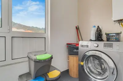 a washing machine in a laundry room with a window at Desert Island Apartment by Atlantic Holiday in Caniço