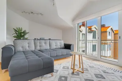 a living room with a couch and a large window at Desert Island Apartment by Atlantic Holiday in Caniço