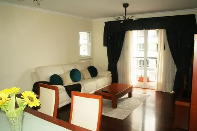 a living room with a couch and a table at Smarts Apartment da Ajuda in Funchal