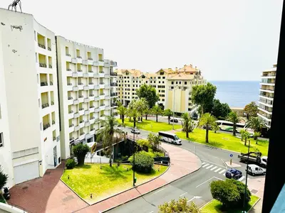 a view of a city street with buildings and the ocean at Smarts Apartment da Ajuda in Funchal