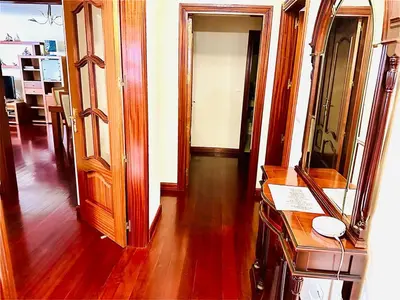 a room with wooden floors and a hallway with a mirror at Smarts Apartment da Ajuda in Funchal