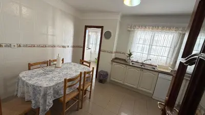 a kitchen with a table with chairs and a sink at Smarts Apartment da Ajuda in Funchal