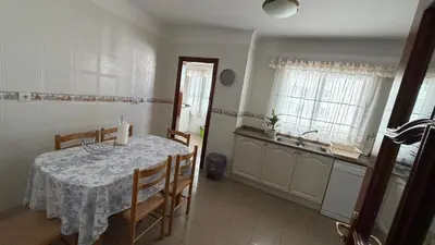 a kitchen with a table and chairs in a room at Smarts Apartment da Ajuda in Funchal