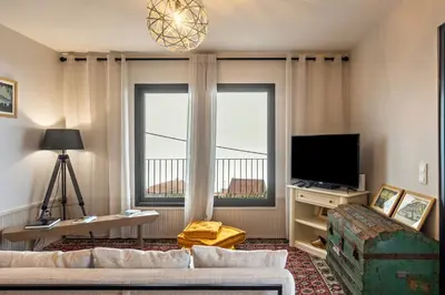 a living room with a couch and a tv and a window at Referta Apartamento T2 in Prazeres