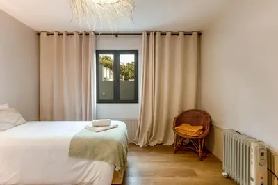 a bedroom with a bed and a window and a chair at Referta Apartamento T2 in Prazeres
