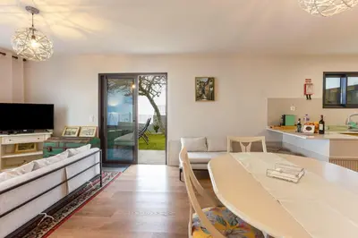 a living room with a table and a couch at Referta Apartamento T2 in Prazeres