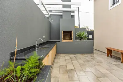 an outdoor kitchen with a sink and a bench at Referta Apartamento T2 in Prazeres