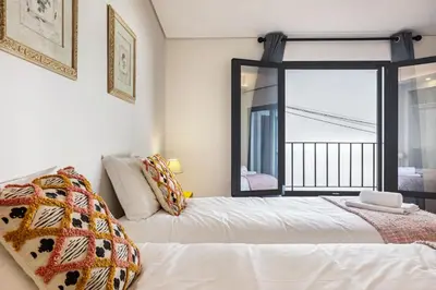 a bedroom with two beds and a mirror at Referta Apartamento T1 in Prazeres