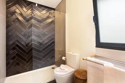 a bathroom with a toilet and a shower at Referta Apartamento T1 in Prazeres