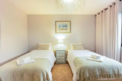 two twin beds in a room with a window at Referta House in Prazeres
