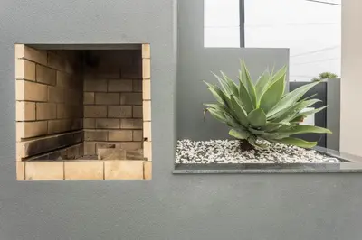 a succulent plant sitting on a ledge next to a brick wall at Referta House in Prazeres