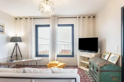 a living room with a couch and a tv at Referta House in Prazeres