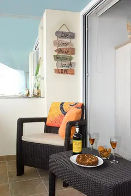 a table with a plate of food and a bottle of wine at Sol do Lido 2 in Funchal