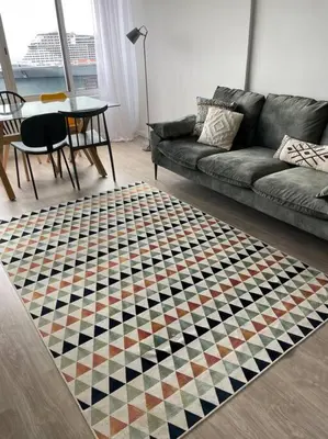 a living room with a couch and a checkerboard rug at top floor avenida arriaga 802 in Funchal