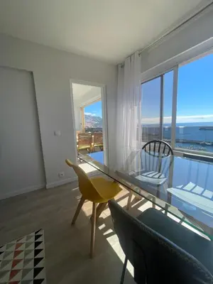 a dining room with a glass table and chairs at top floor avenida arriaga 802 in Funchal