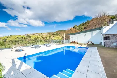 a swimming pool in the backyard of a house at Ocean Panorama Apartments by Homie in Calheta