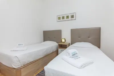 two beds in a room with white sheets at B81 - Casa do Outeiro Westcoast Home in Vila do Bispo