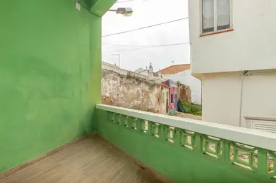 an empty balcony with a green wall and wooden floors at B81 - Casa do Outeiro Westcoast Home in Vila do Bispo