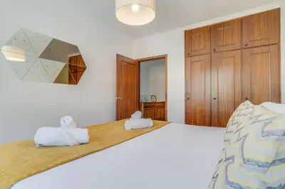 a bedroom with a large bed with two towels at Yellow Rose by AH in Funchal