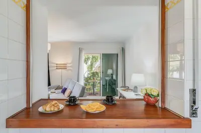 a kitchen with a counter with a plate of food at Yellow Rose by AH in Funchal