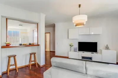 a living room with a couch and a flat screen tv at Yellow Rose by AH in Funchal