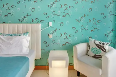 a bedroom with a bed and a chair at Dfm Happy Days E - Funchal in Funchal