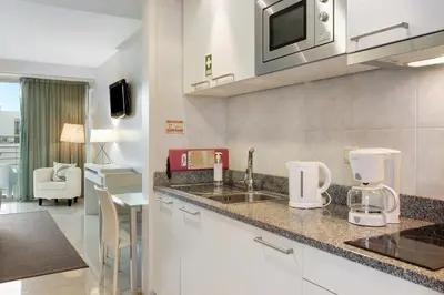 a kitchen with a sink and a microwave at Dfm Happy Days E - Funchal in Funchal