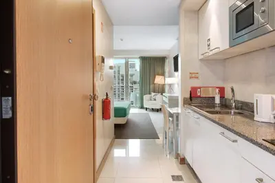 a kitchen with a sink and a living room at Dfm Happy Days E - Funchal in Funchal