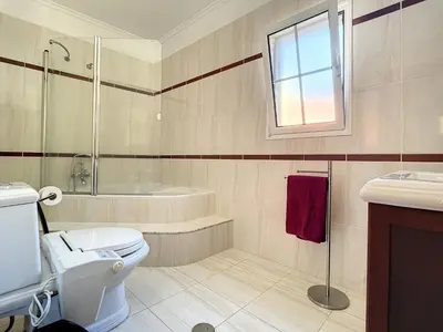a bathroom with a toilet and a tub and a sink at Mountain View Villa by Atlantic Holiday in São Vicente